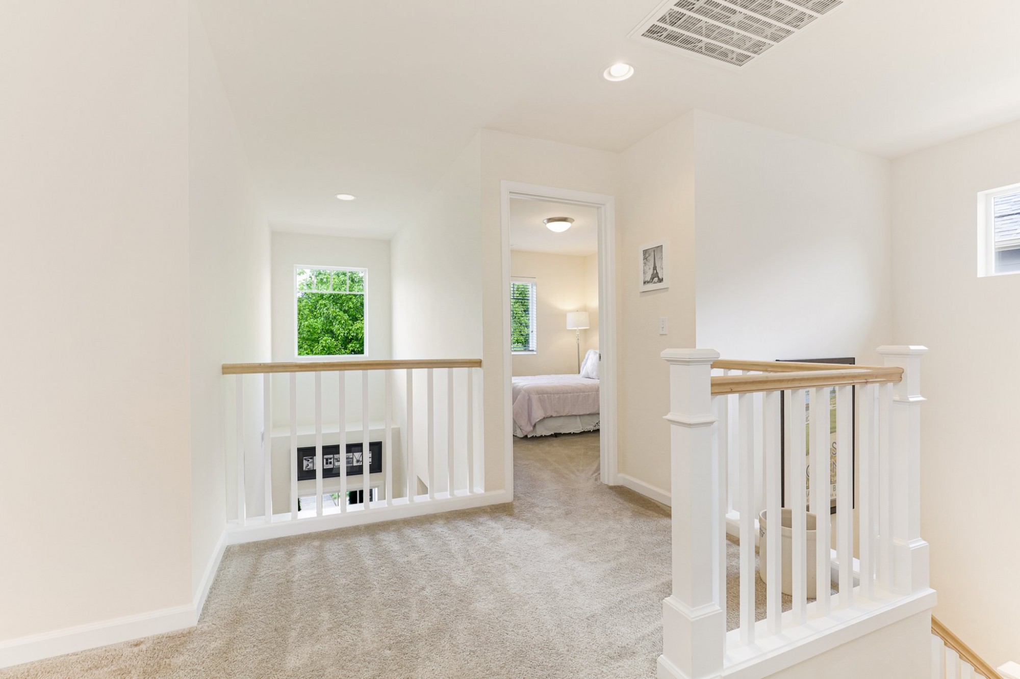 Upper level overlooks the entry and features beautiful railings.